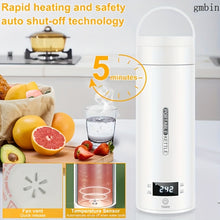 Portable kettle with digital display on a kitchen counter, surrounded by fruits and a glass of water.